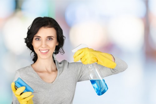 Technician treating upholstery stains on a fabric sofa