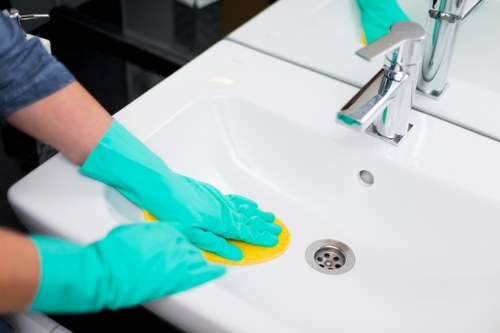 Cleaner wearing PPE during carpet cleaning in Brixton